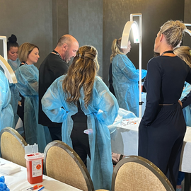 cosmoglo light is the best light for medical aesthetics and surgery. CosmoGlo being used to perform cadaver surgery at the Aesthetic Next event.