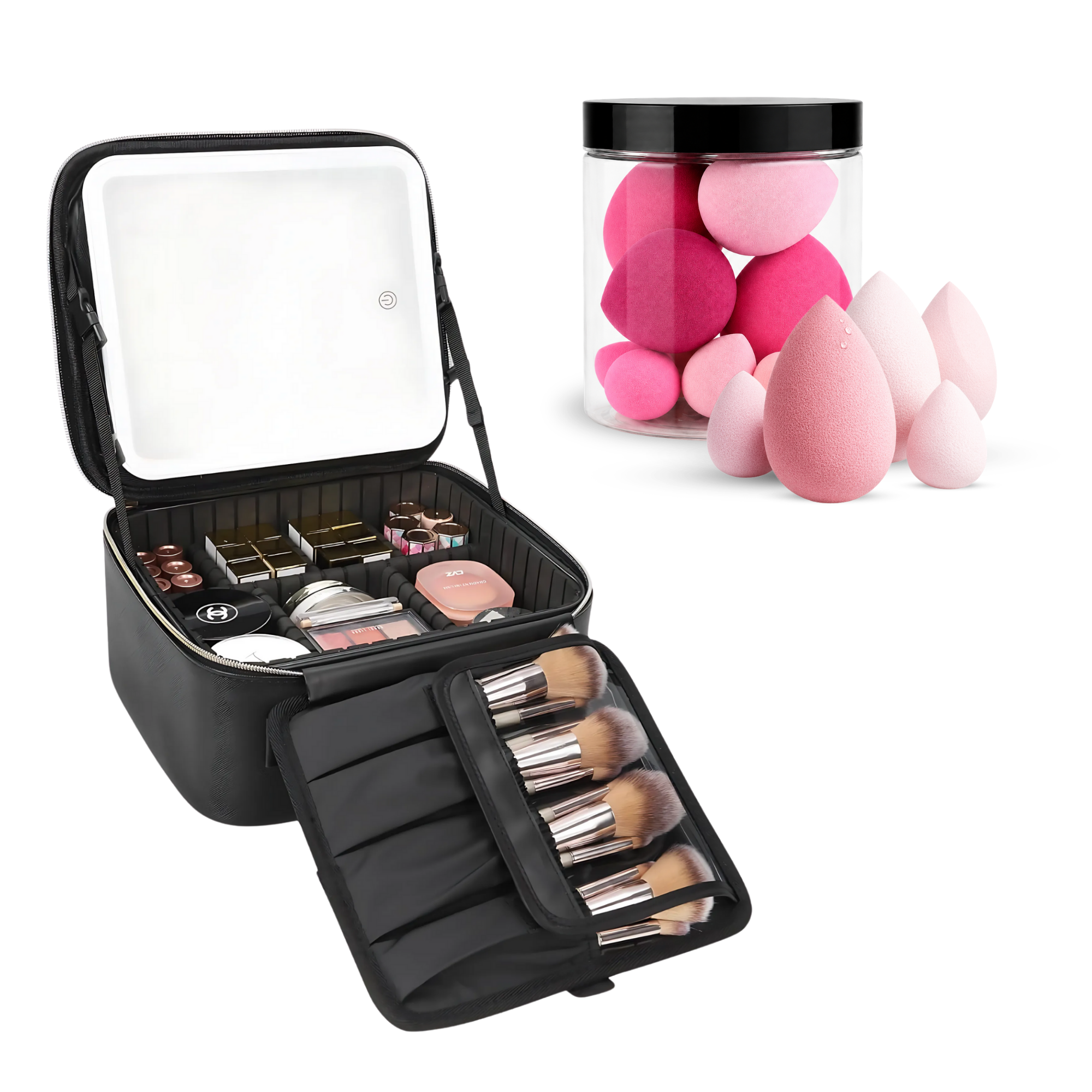 An open black makeup organizer case shown on a white background, with a mirror on the inside lid, makeup items in the main compartment, brush handles in an attached roll-out section, and several pink teardrop makeup sponges displayed beside it in a clear jar.