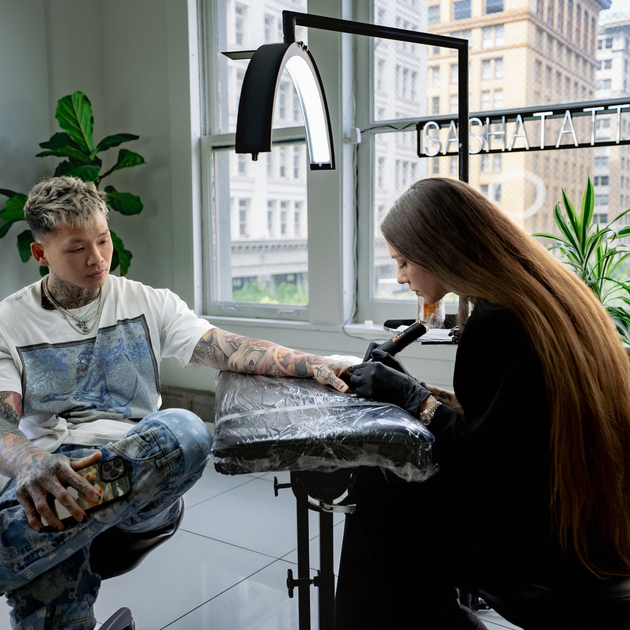 Tattoo artist working on a client&