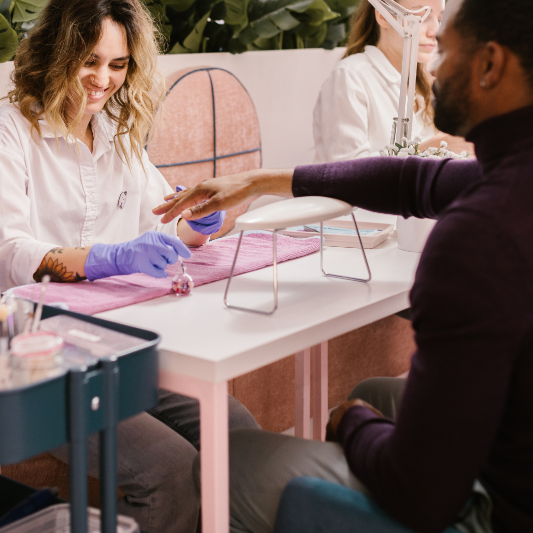 A nail technician taking care of a VIP client