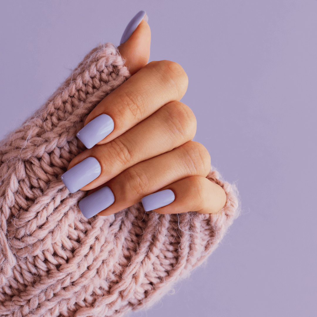 Girl's hands with a soft purple manicure