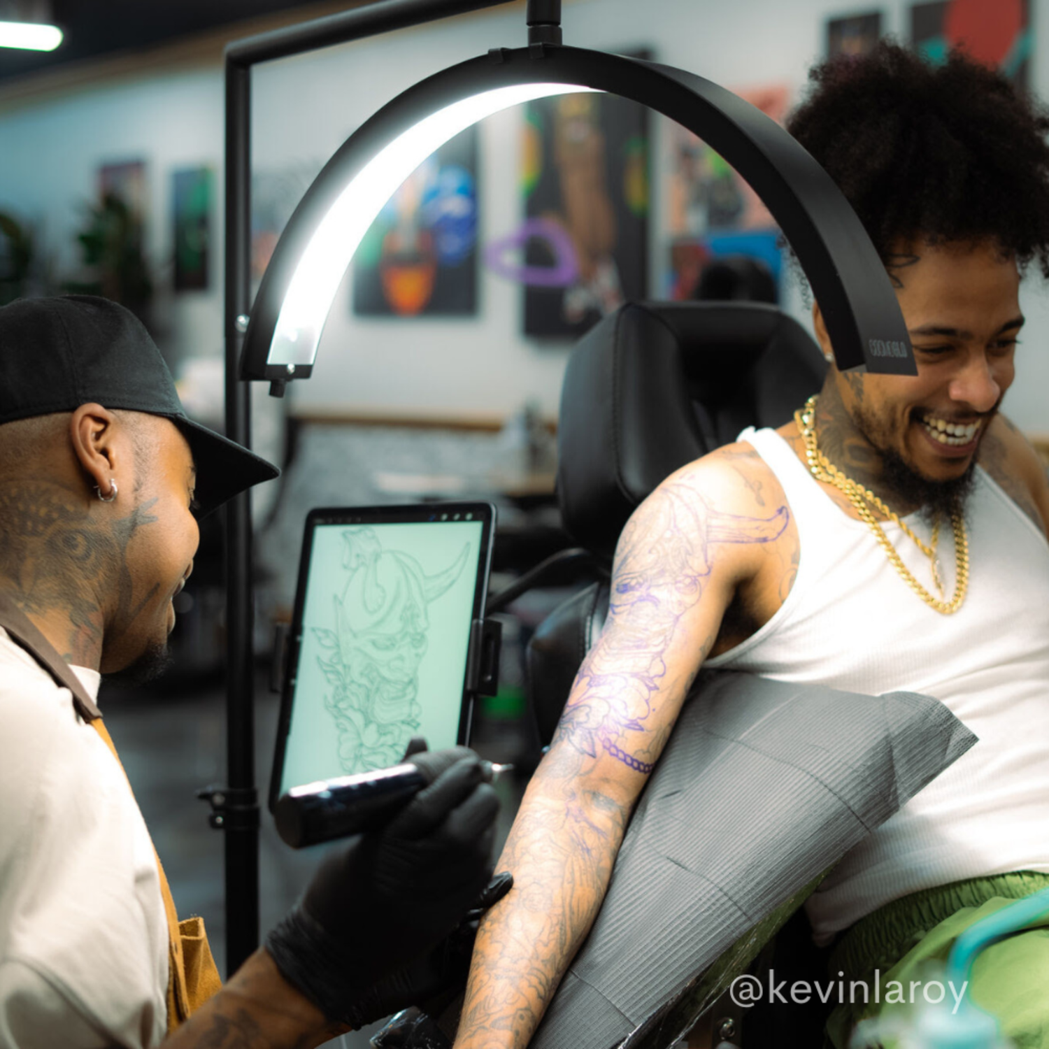 Tattoo artist under CosmoGlo light