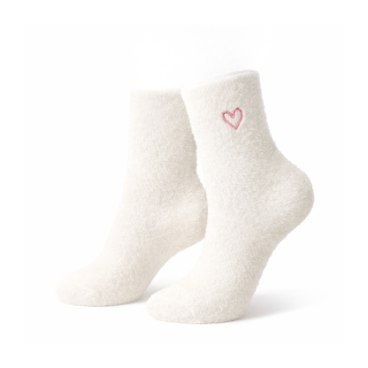 Pair of white socks with a pink heart design on a white background