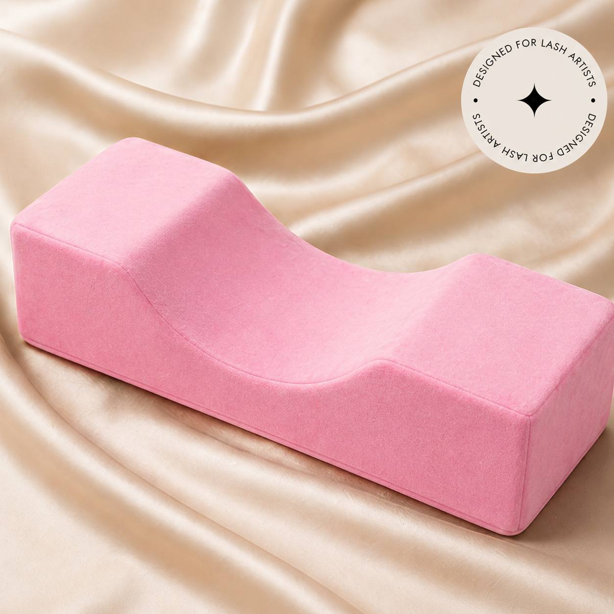 Pink wedge-shaped pillow on a beige fabric background with &