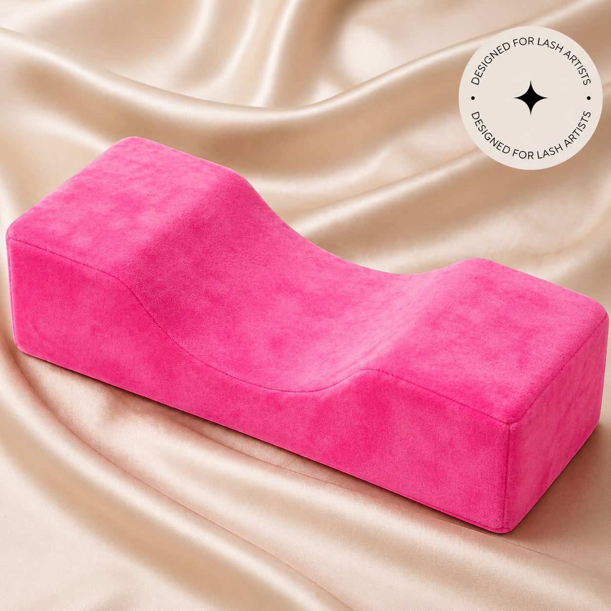 Pink cushion designed for lash artists on a satin background