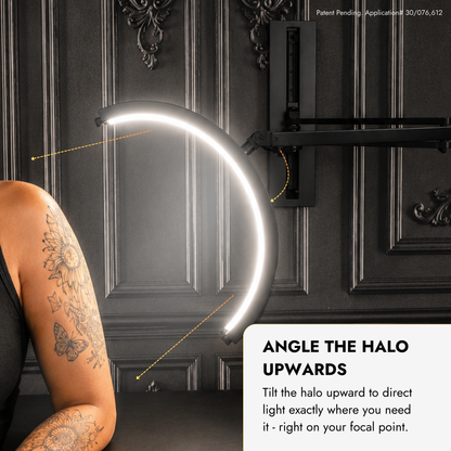 A curved LED halo light mounted on a dark paneled wall, shown with a tattooed person&