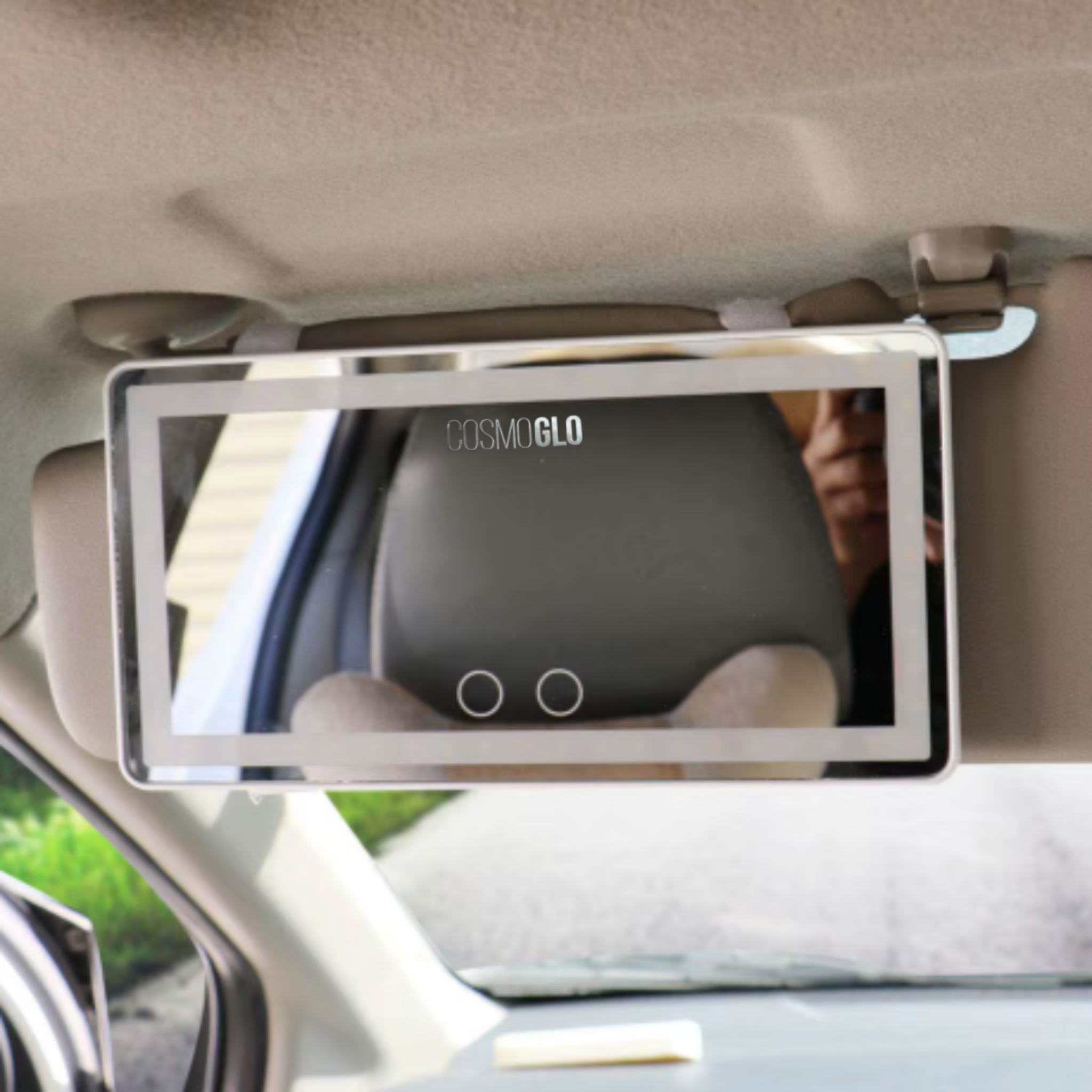 Lighted car visor mirror accessory by The CosmoGlo, showing a compact mirror with built-in LED lighting for enhanced visibility.
