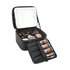 Black makeup case with light up led mirror with open lid and compartments filled with makeup items.