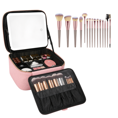 A pink makeup case shown open, with a built-in mirror on the lid, makeup items inside the case, and a set of makeup brushes displayed above and in the front pocket. The brushes have light pink bristles and metallic rose-gold handles.