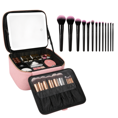 A pink makeup case shown open on a white background, with a built-in mirror on the lid, cosmetics inside, and multiple makeup brushes arranged in front and above the case. The brushes have black handles and pink-purple bristles.