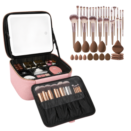 A pink makeup vanity case shown open, filled with cosmetics, alongside a large set of makeup brushes, sponges, and applicators on a white background.