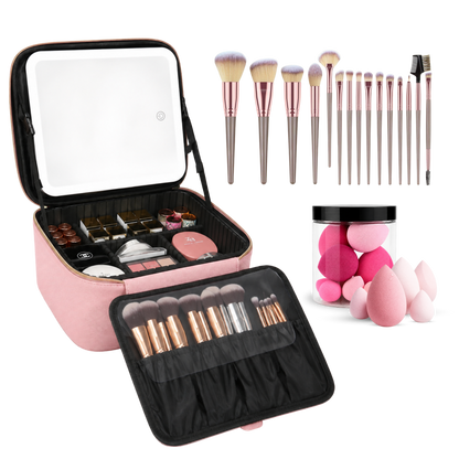 A makeup brush and case set displayed on a white background, including a pink zip cosmetic case with an open mirror, multiple makeup brushes in rose gold and beige bristles, a jar of pink makeup sponges, and several makeup sponges scattered around.