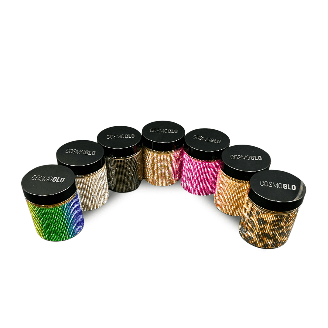CosmoGlo Halo Accents - all seven color variations are lined up in a semi-circle inside round, clear jars with black lids.