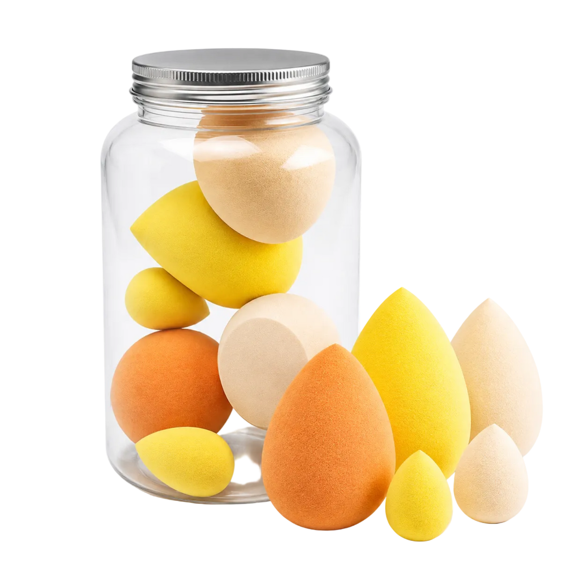 A clear glass jar with a silver metal lid containing multiple teardrop-shaped makeup sponges in yellow, orange, and beige, with several sponges placed in front on a white background.